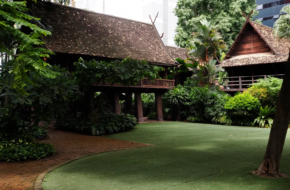เรือนคำเที่ยง (Kamthieng House) เรือนไม้สักล้านนาโบราณที่อนุรักษ์ไว้ ณ สยามสมาคม แสดงเสาไม้ยกใต้ถุนสูงและปั้นลมกาแลชัดเจน